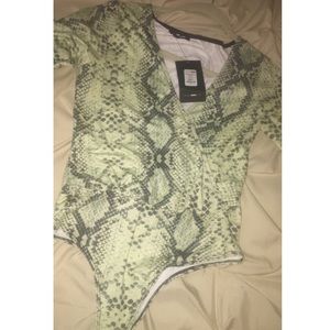 Green snakeskin long sleeve bodysuit.